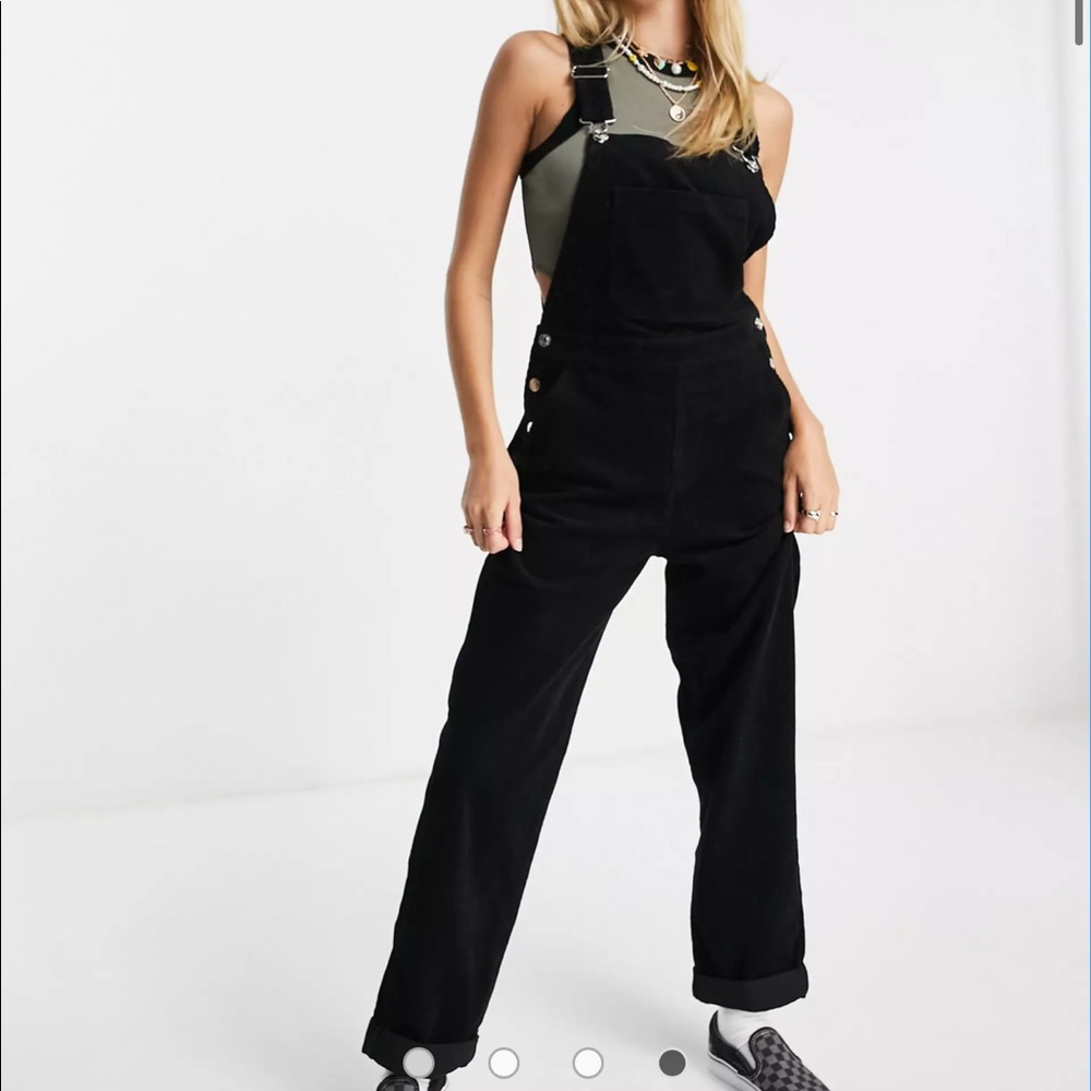 Black corduroy overalls.